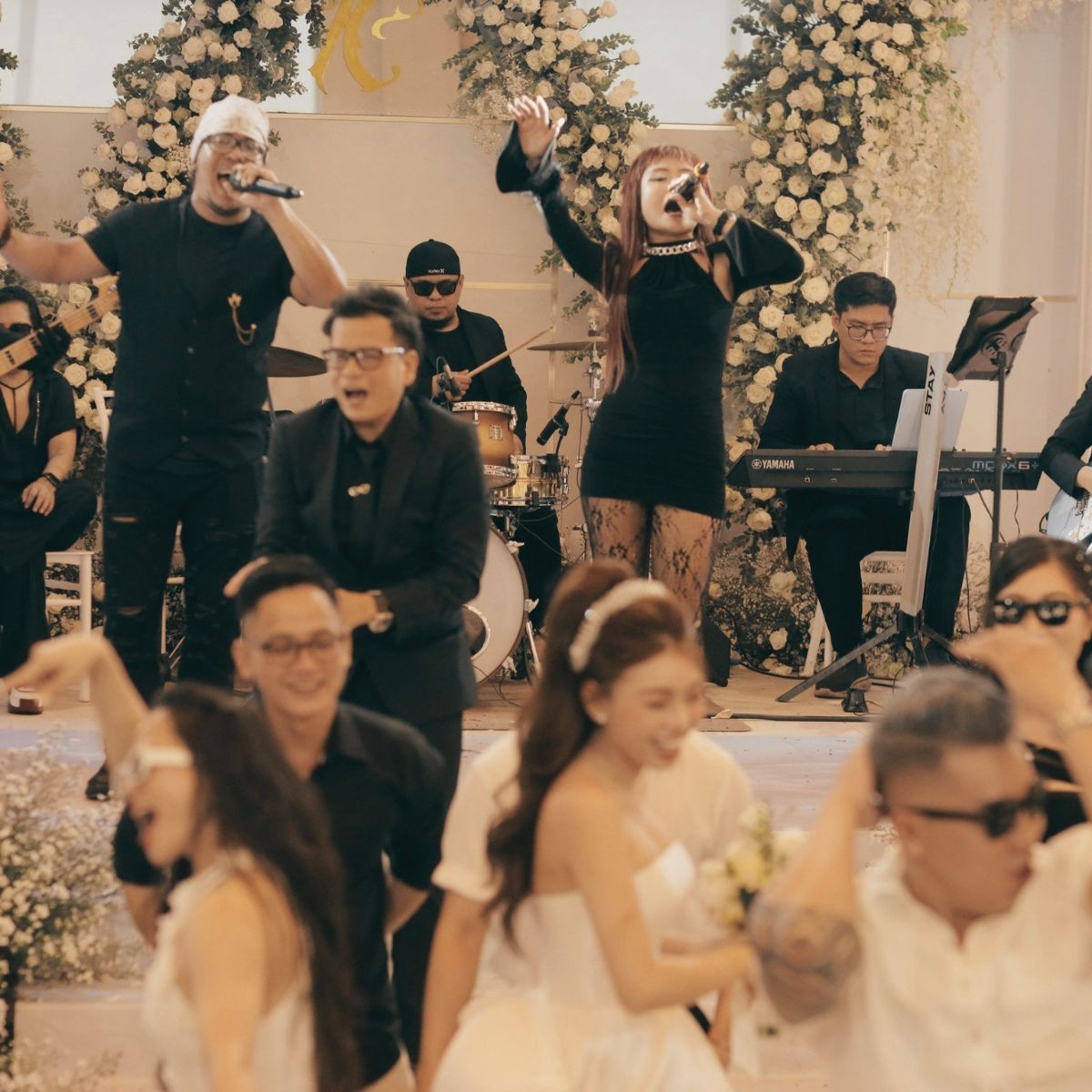 Modern live band building energy during a ballroom wedding reception