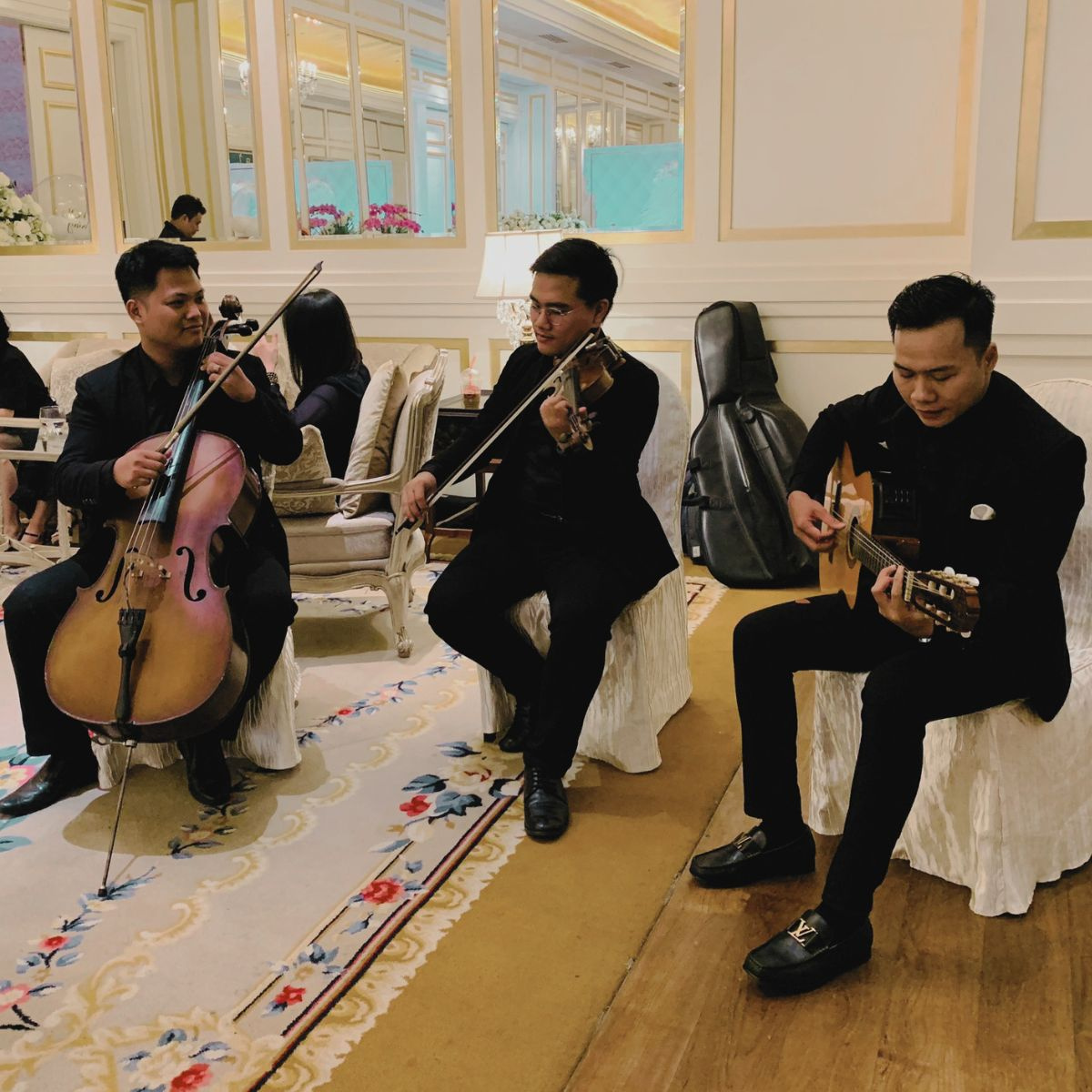 Lux Band trio performing cello, violin and guitar during a wedding at Park Hyatt Saigon
